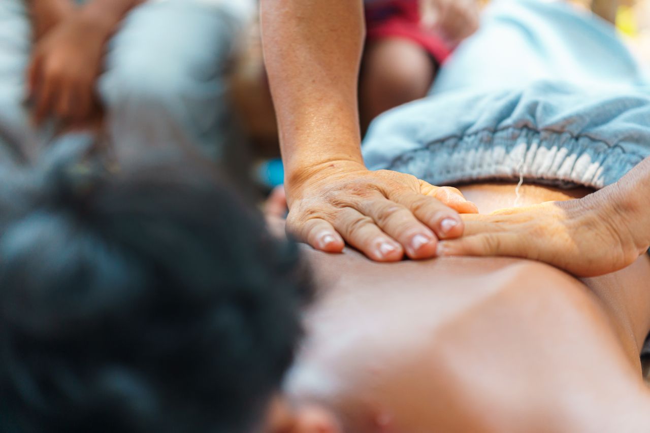 Close-up of a relaxing back massage being given outdoors, capturing the soothing atmosphere.